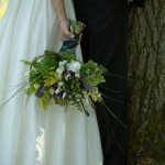 A country bride and groom with country flowers