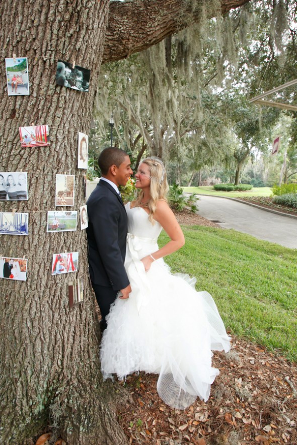 Pictures Hanging From Trees At Wedding
